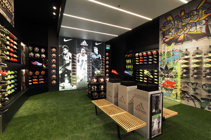 In2Sports Retail Store by Unfold Creative Studio - The Boot Room was designed to for ease of shopping based on consumer habits. The large scale custom graffiti was introduced to represent and showcase street soccer.